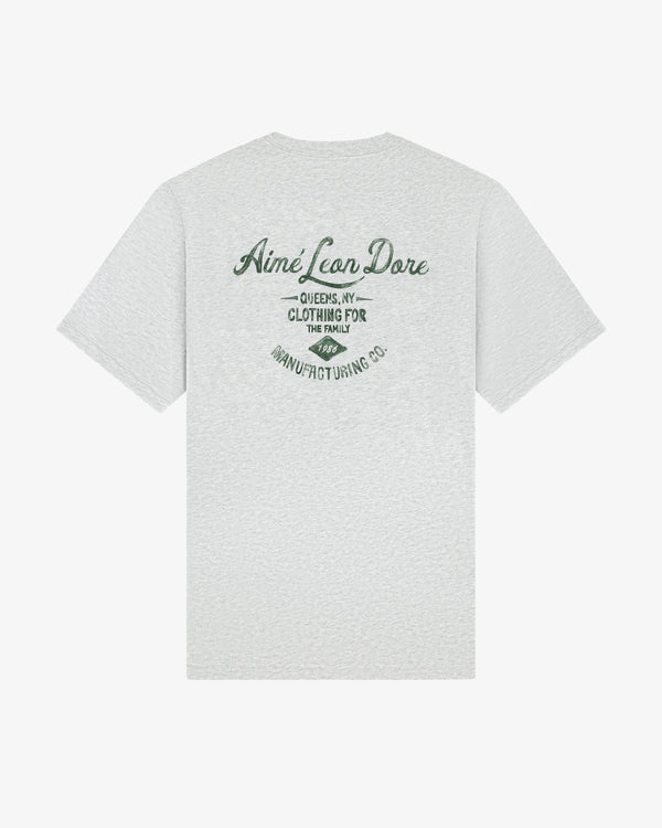 Light gray General Store Pocket Tee with green "Aimé Leon Dore, Queens, NY, Clothing for the Family" text on back.
