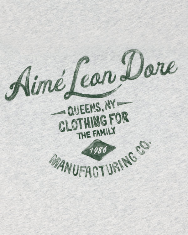 Gray General Store Pocket Tee with green “Aimé Leon Dore, Queens NY, Clothing for the Family, 1986, Manufacturing Co.”.