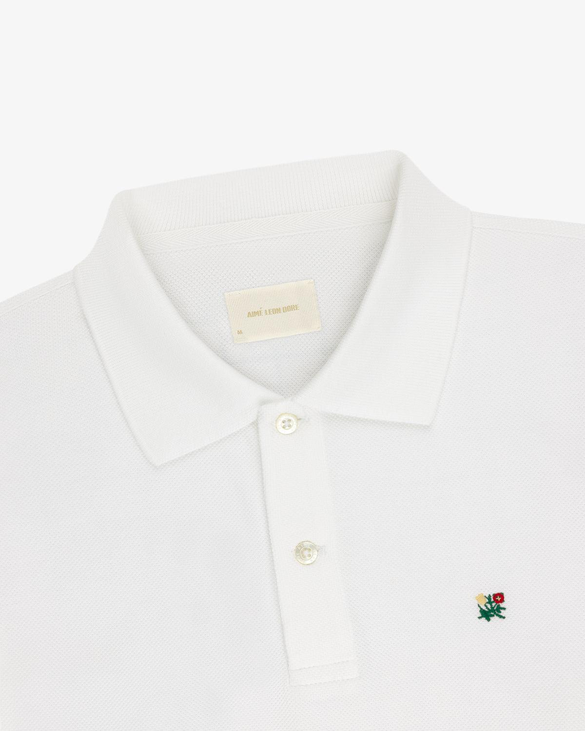 White Long-Sleeve Crest Piqué Polo with a collar, two buttons, and small embroidered rose logo on chest.