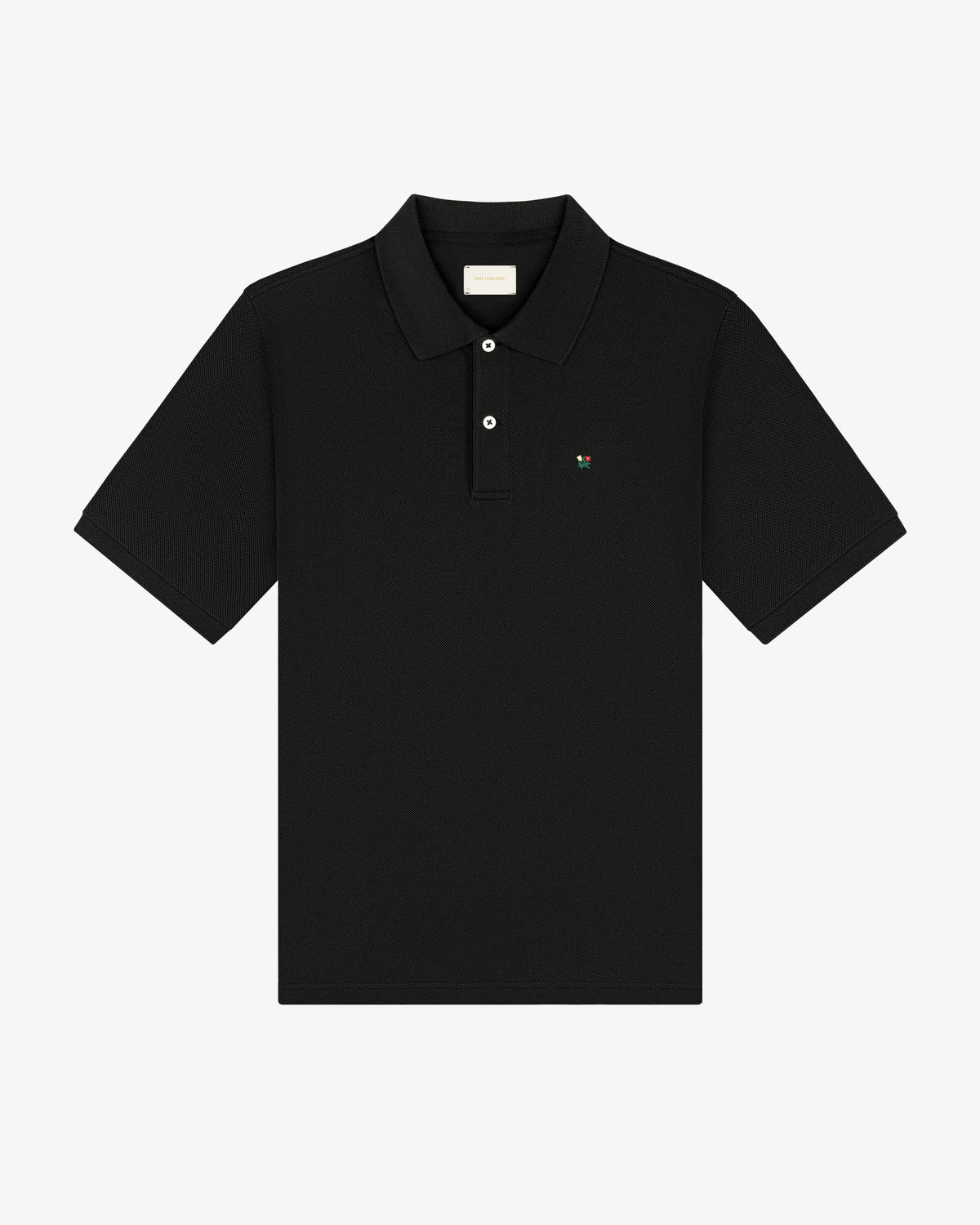 Crest Piqué Polo—black short-sleeve shirt with collar, button placket, and small chest logo.