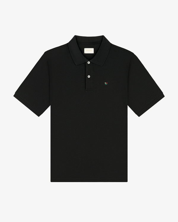 Crest Piqué Polo—black short-sleeve shirt with collar, button placket, and small chest logo.
