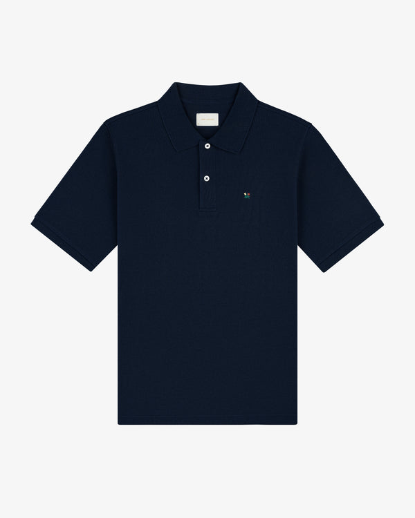 Crest Piqué Polo: Navy short-sleeve, collared shirt with two buttons and a small embroidered chest logo.