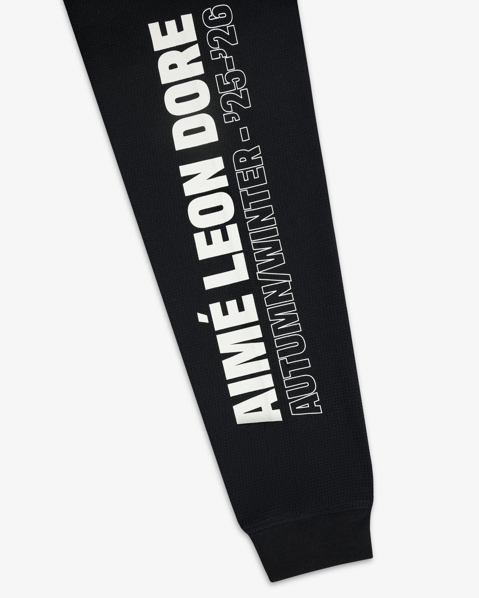 Black Long-Sleeve Mesh Moto Tee with “AIMÉ LEON DORE AUTUMN/WINTER - 25-26” in white text running vertically.