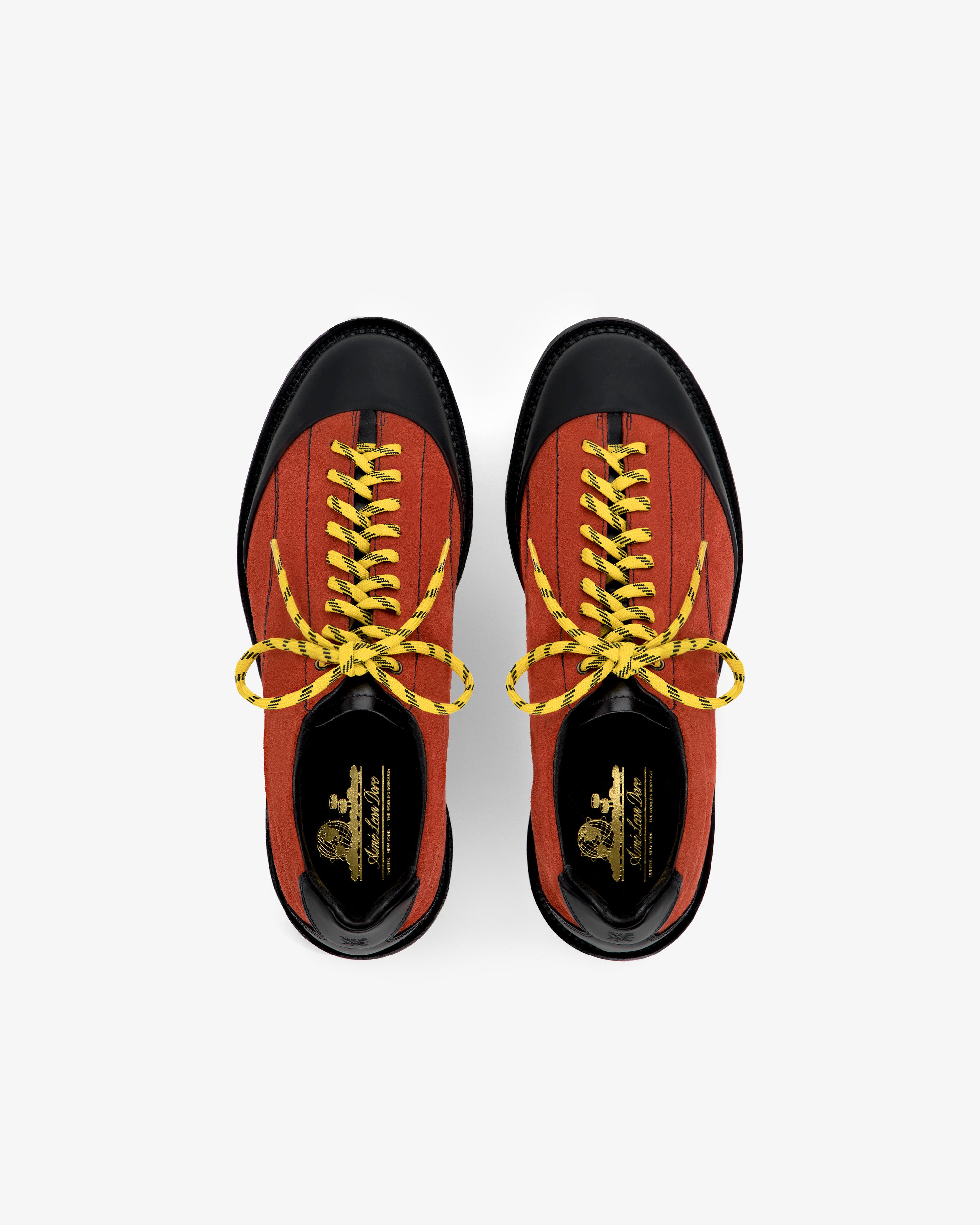 Top view of Suede Derby Hiker in red with black toes and yellow laces on a white background.