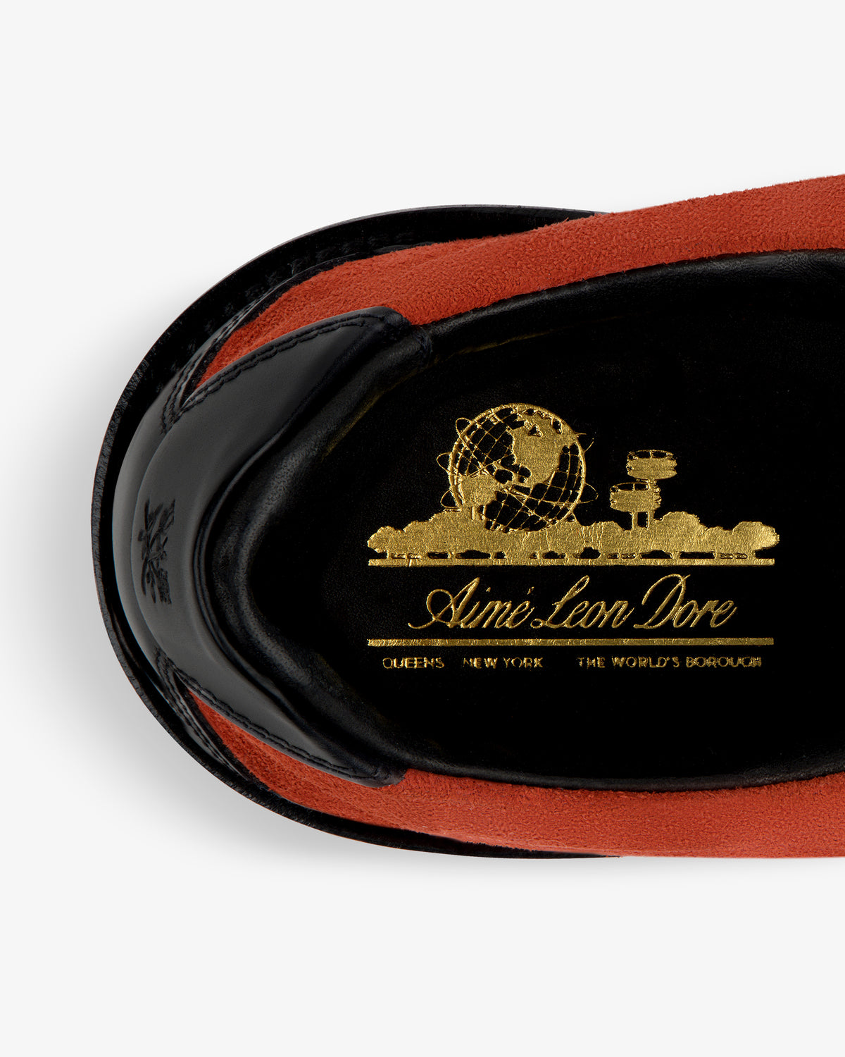 Close-up of Suede Derby Hiker insole with a gold globe graphic and “Aime Leon Dore” text on black.