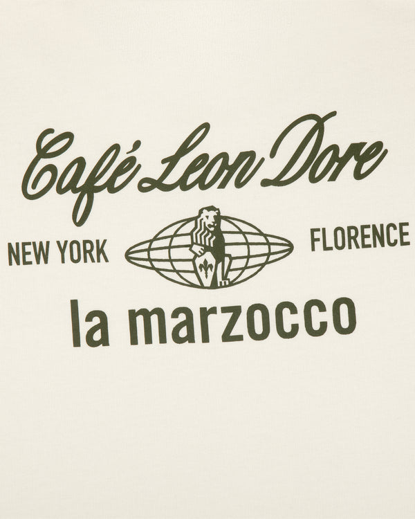 White tee with black Café Leon Dore, New York, Florence, la marzocco text and lion logo at the center.