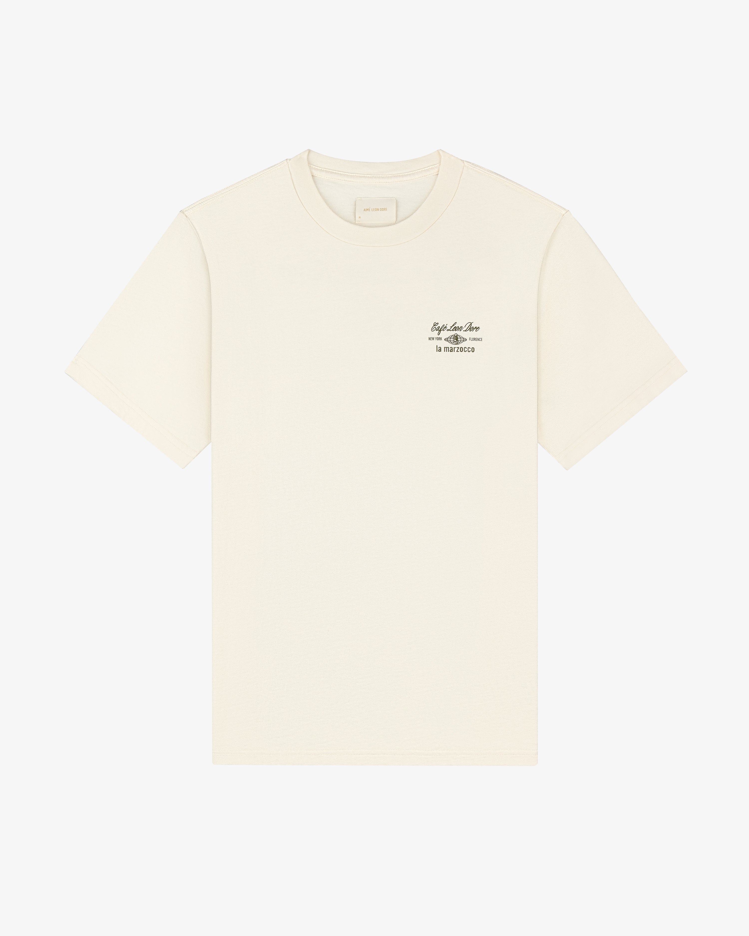 Café Leon Dore / La Marzocco Tee in off-white with small black text on the left chest, shown on a white background.
