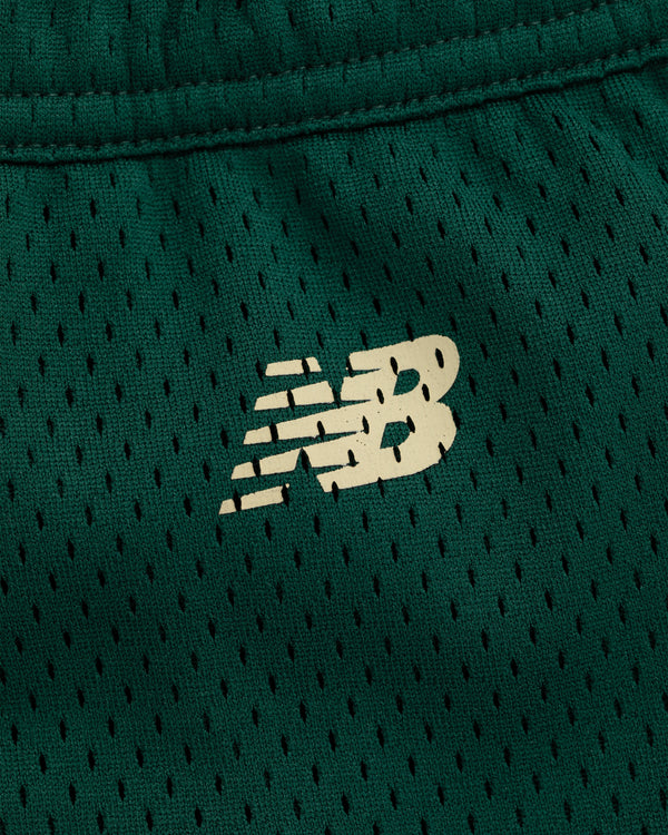 Close-up of a white New Balance logo on green mesh ALD / New Balance SONNY NY Gym Short.