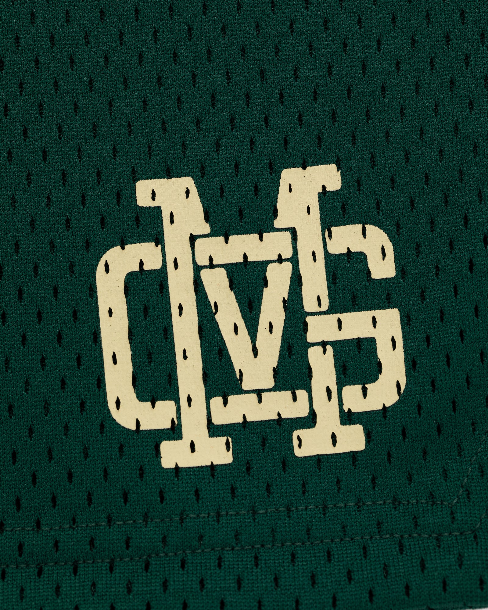 ALD / New Balance SONNY NY Gym Short features a white stylized DVS logo on green mesh fabric with small holes.