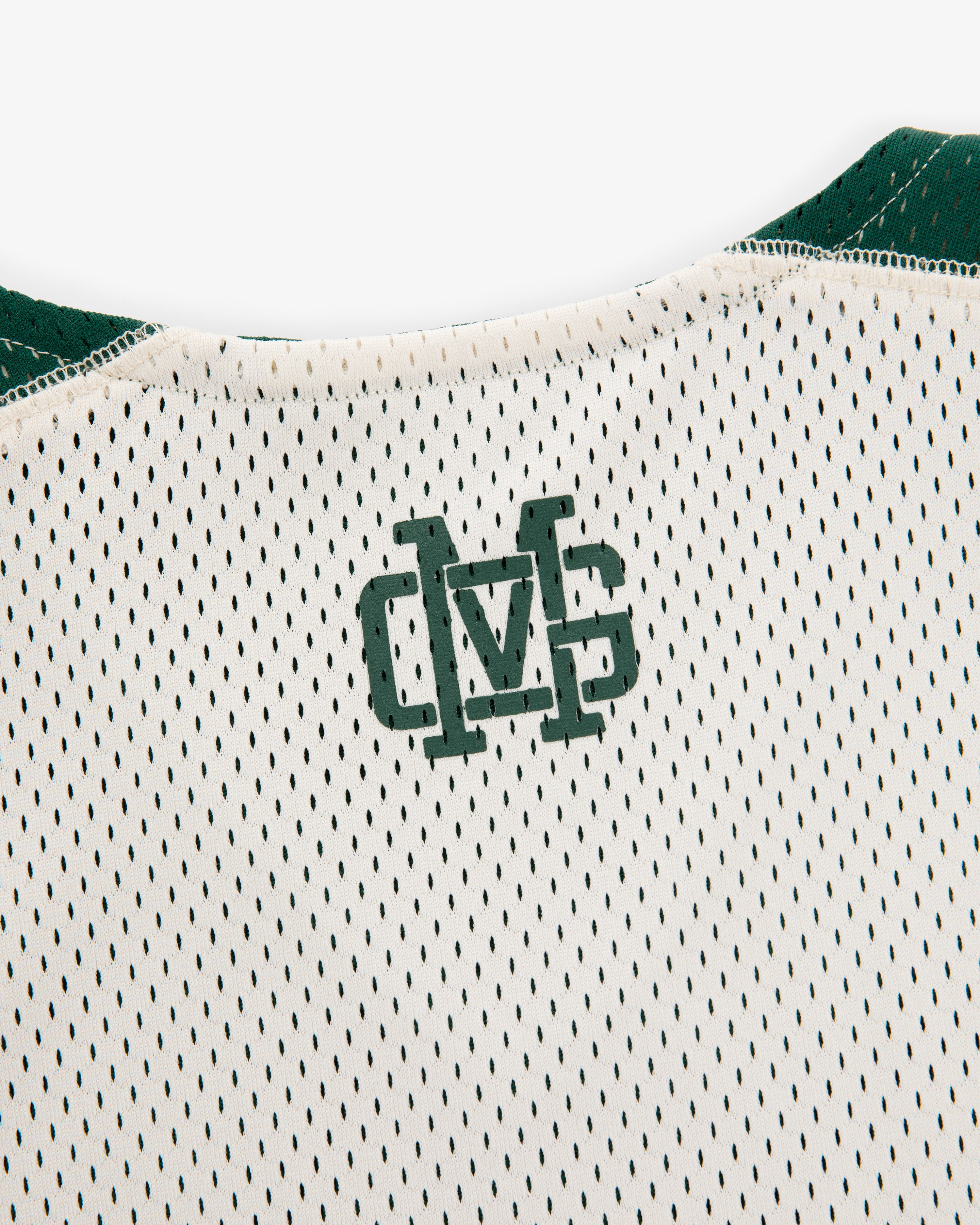 Close-up of the ALD / New Balance SONNY NY Reversible Jersey's back neck with green overlapping “MS” letters.