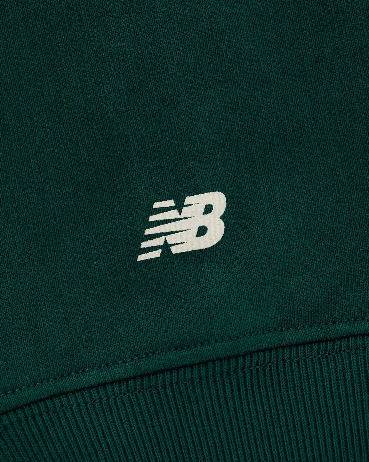 Close-up of the ALD / New Balance SONNY NY IFTB Crewneck Sweatshirt in dark green with a white NB logo.