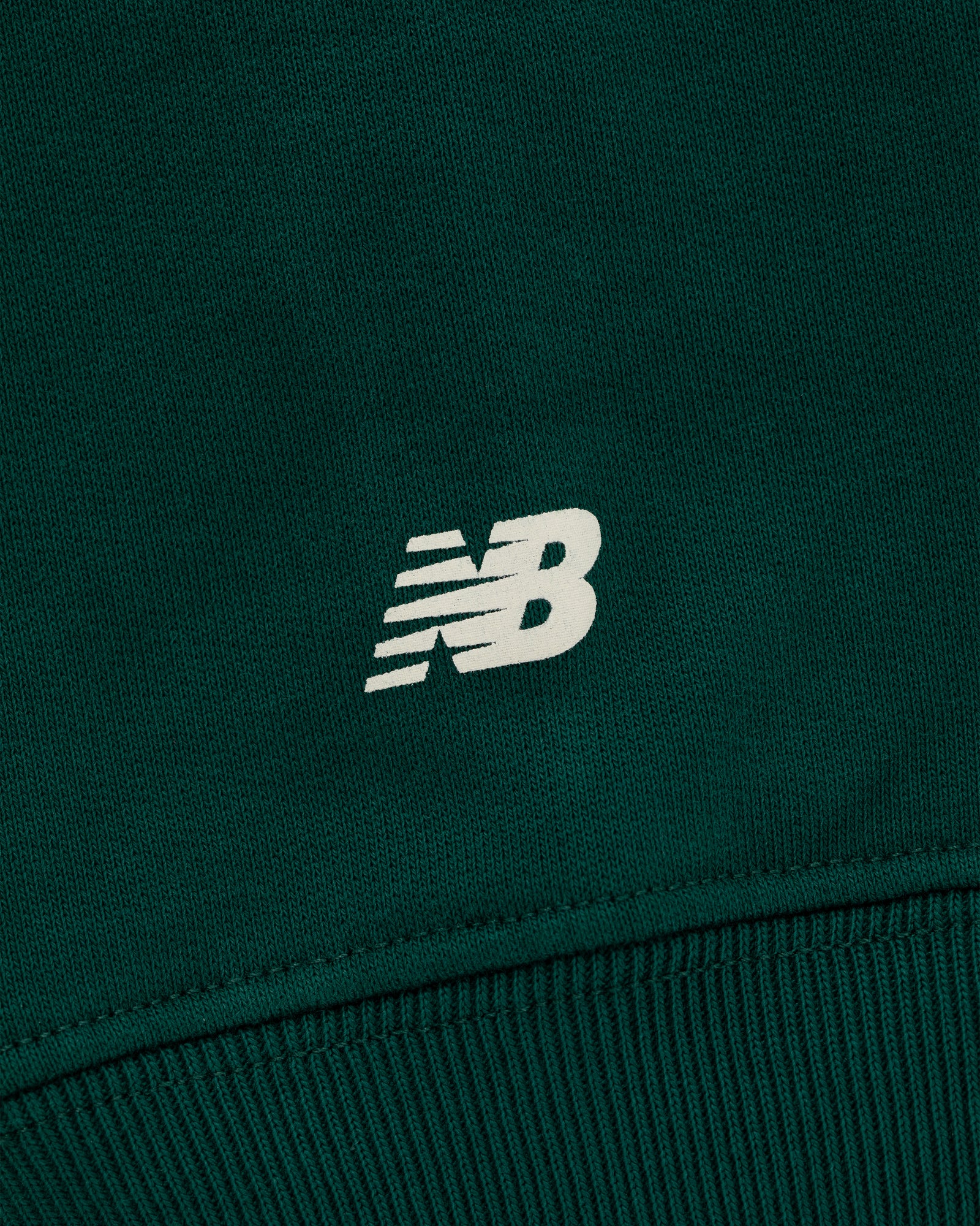 Close-up of the ALD / New Balance SONNY NY IFTB Crewneck Sweatshirt in dark green with a white NB logo.