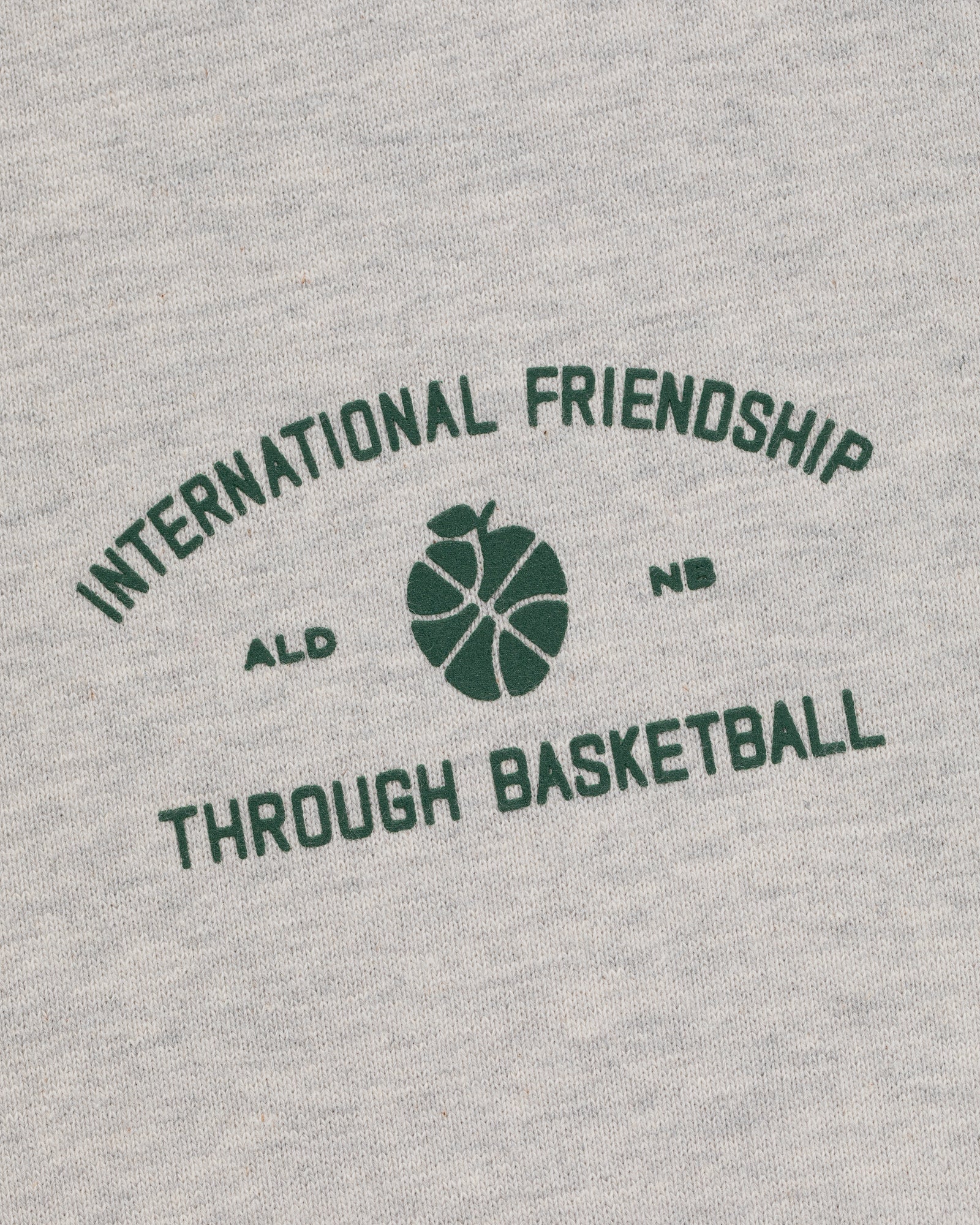 Gray ALD/New Balance SONNY NY IFTB Crewneck with green "International Friendship Through Basketball" text.