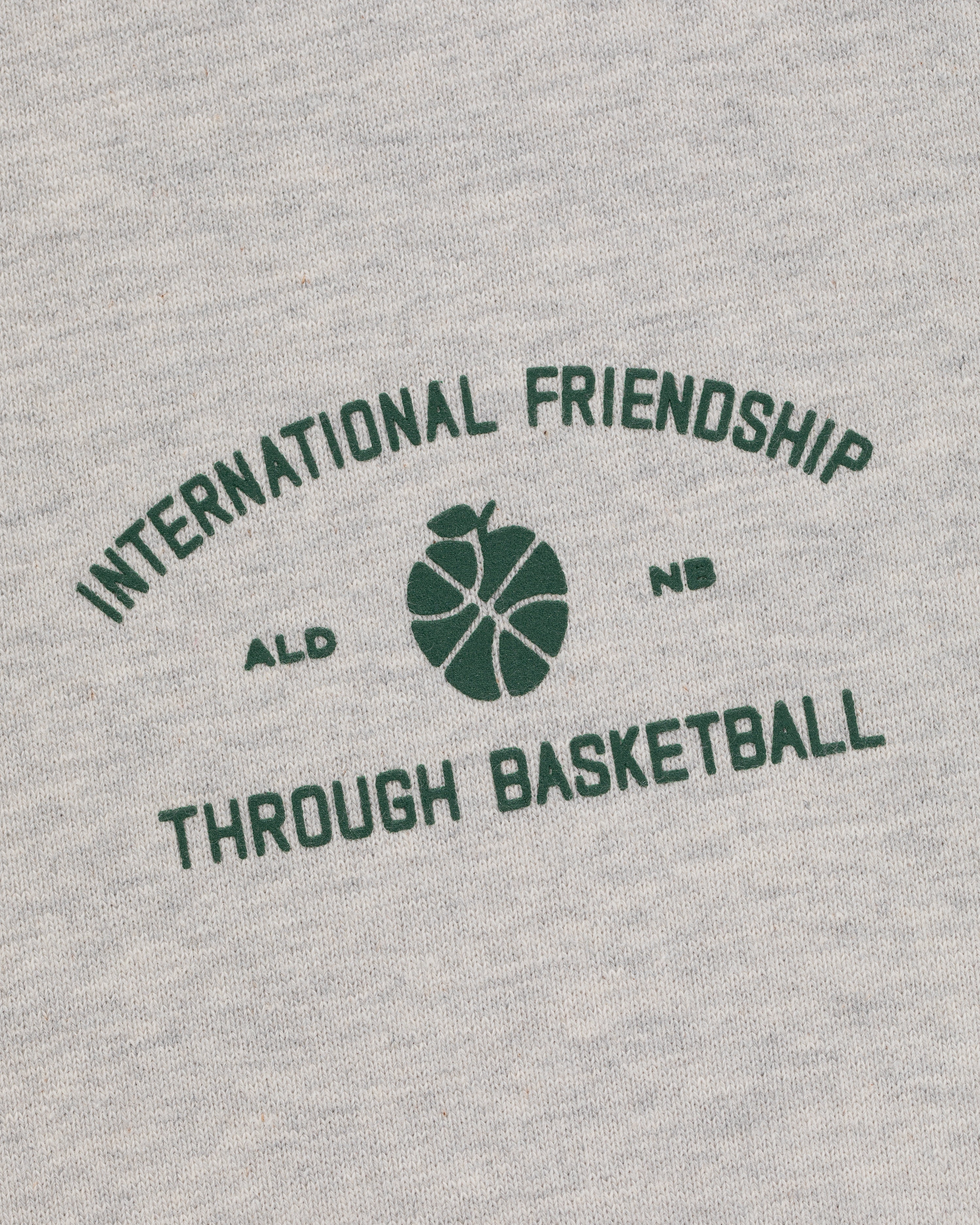 Gray ALD/New Balance SONNY NY IFTB Crewneck with green "International Friendship Through Basketball" text.