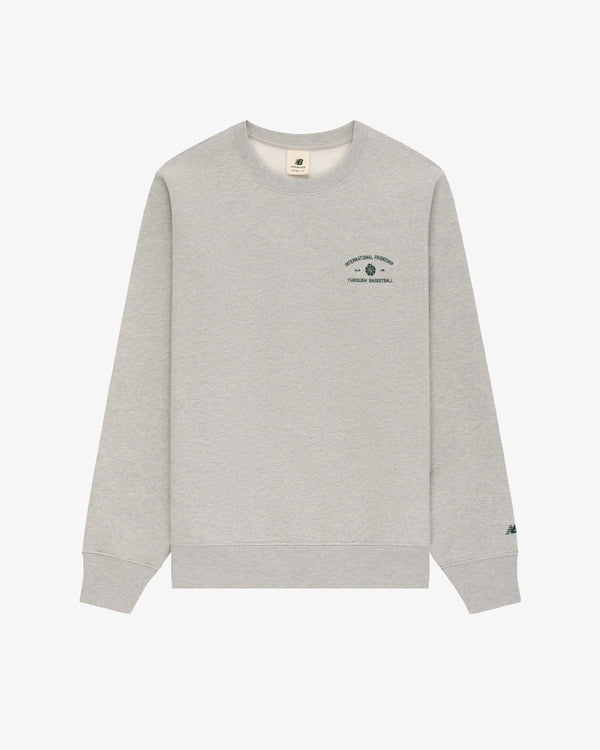 ALD / New Balance SONNY NY IFTB light gray crewneck with small green chest text/logo and left sleeve detail.