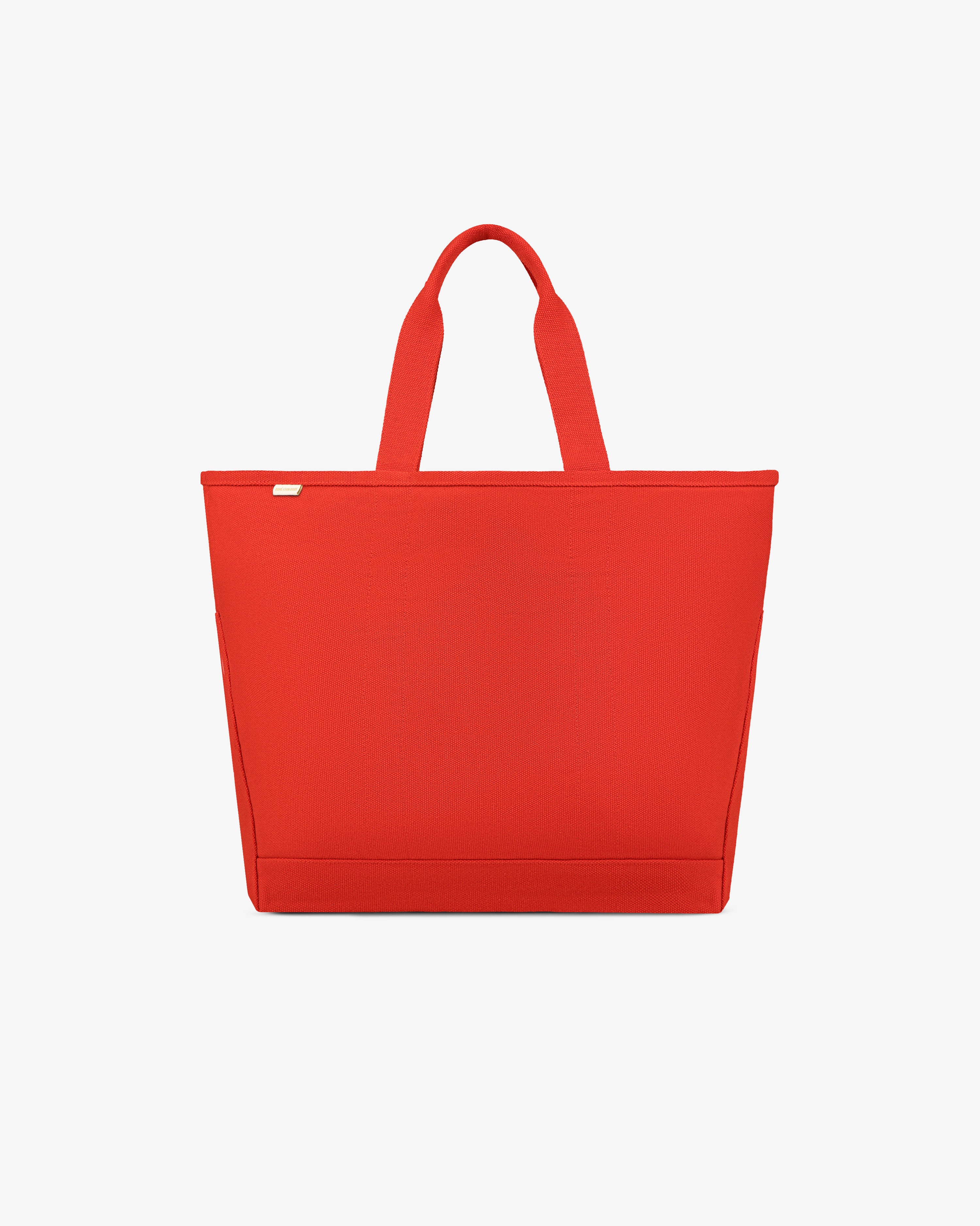 Large Unisphere Tote Bag in bright red with two handles, shown against a plain white background.