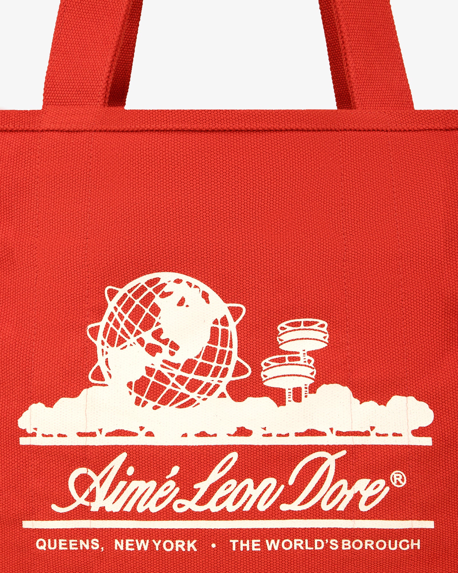 Large Unisphere Tote Bag: Red with white Unisphere and pavilion graphic, Aimé Leon Dore text, Queens, New York.