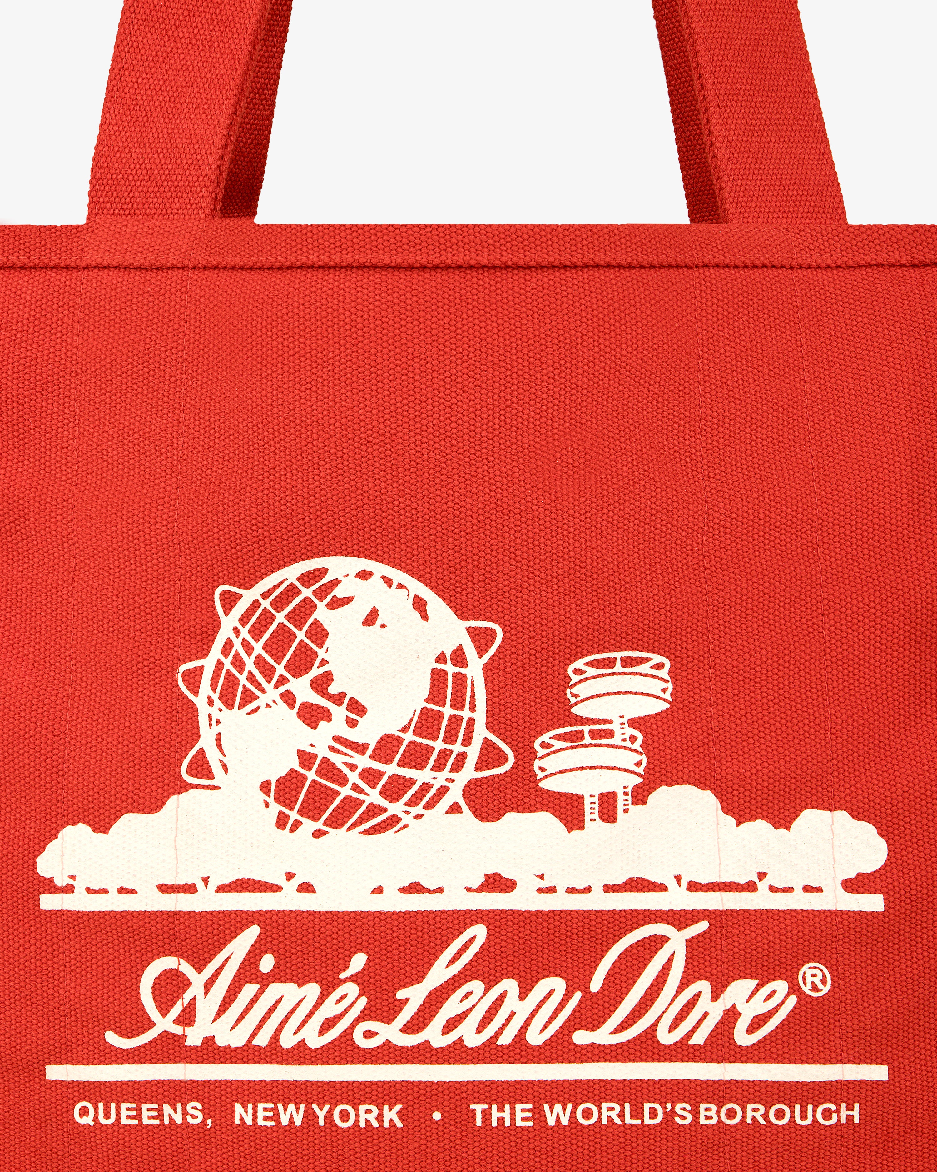 Large Unisphere Tote Bag: Red with white Unisphere and pavilion graphic, Aimé Leon Dore text, Queens, New York.