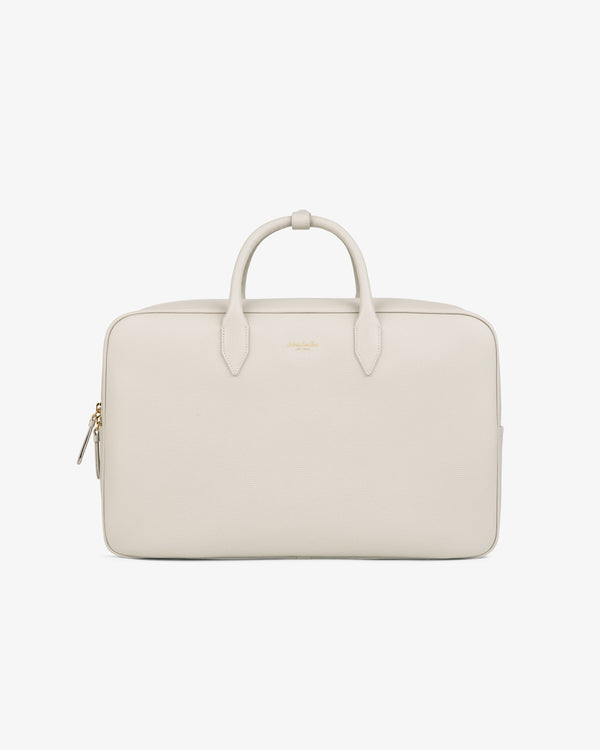 A minimalist, light beige Full Grain Leather Briefcase Duffle with two handles, zipper, and gold-tone hardware.