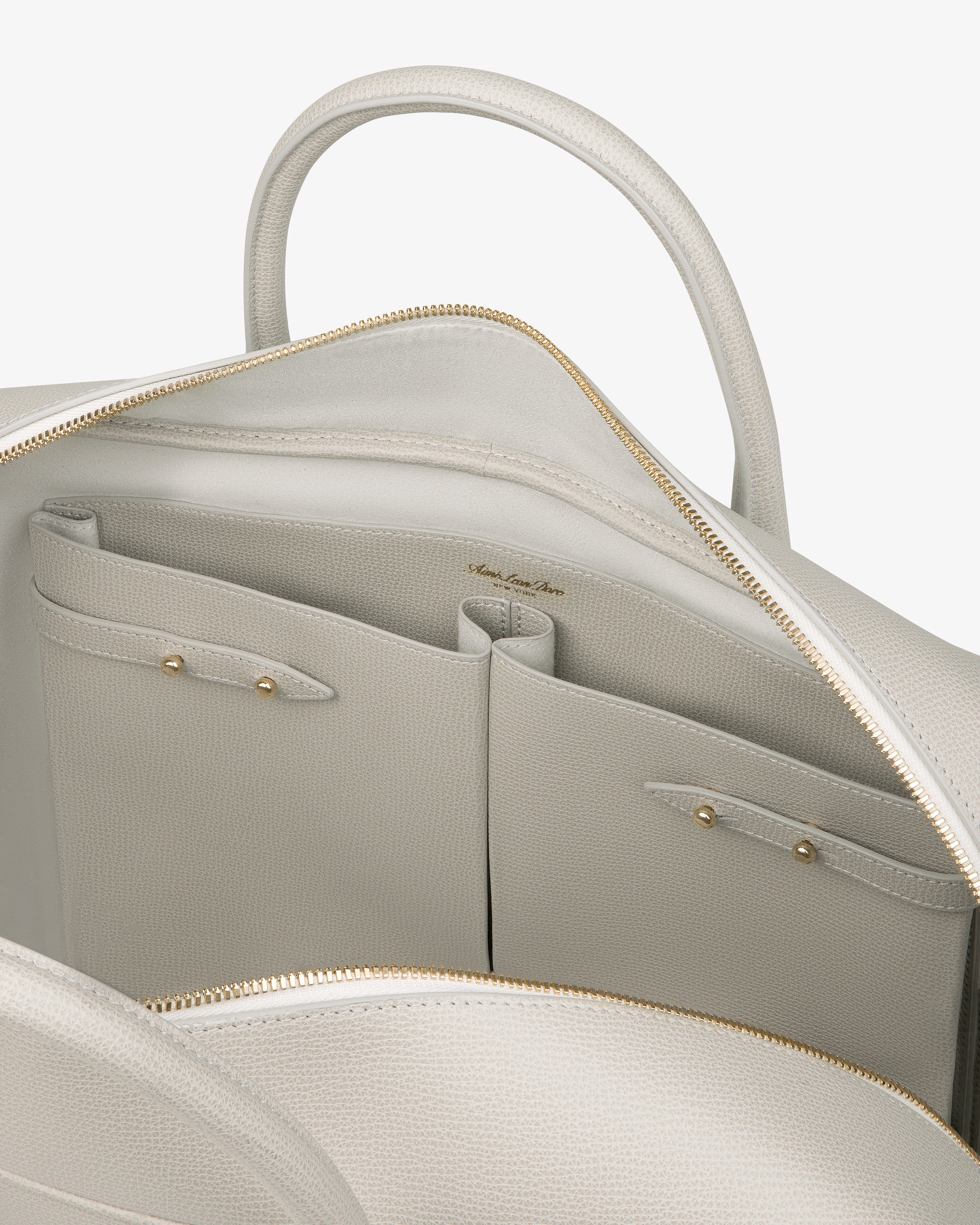 Open light gray Full Grain Leather Briefcase Duffle showing two interior pockets with gold snaps and textured lining.