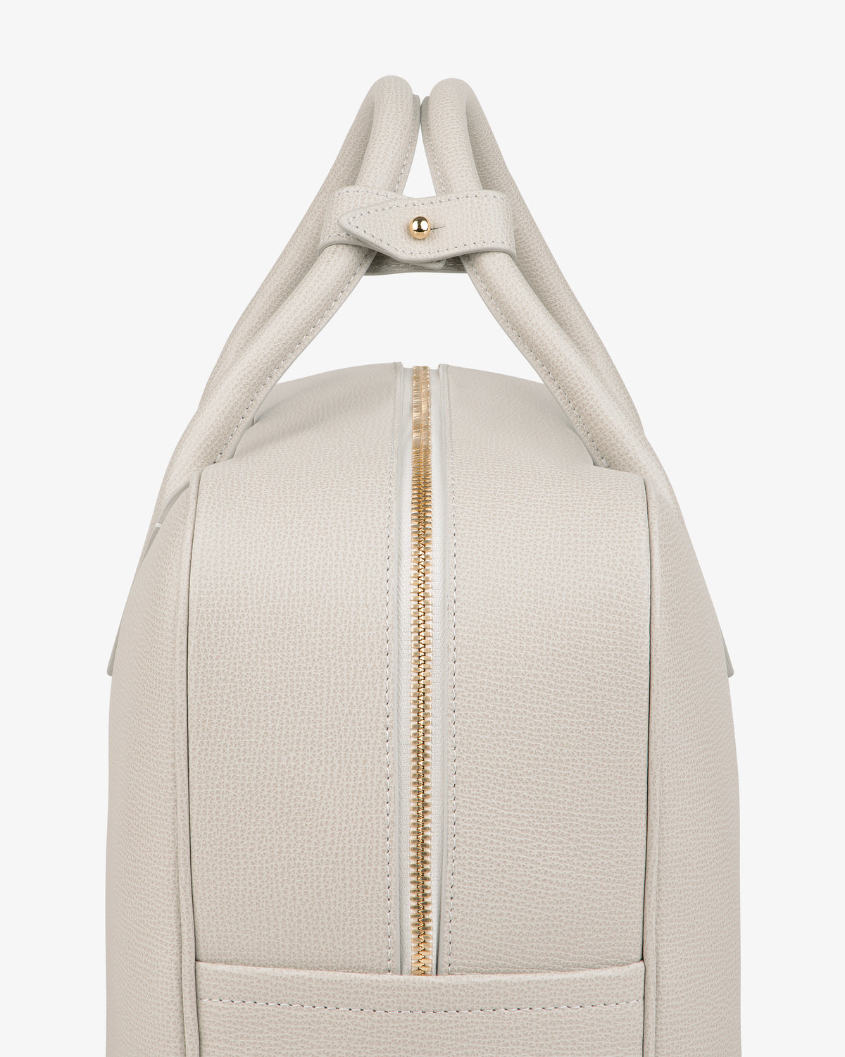 Side view of the Full Grain Leather Briefcase Duffle in light beige textured leather with gold zipper and double handles.