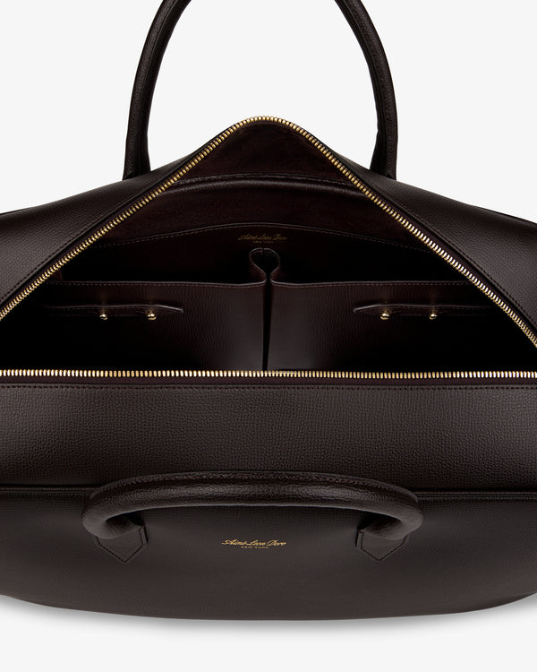 A Full Grain Leather Briefcase Duffle with gold zipper, organized interior pockets, and dual handles.
