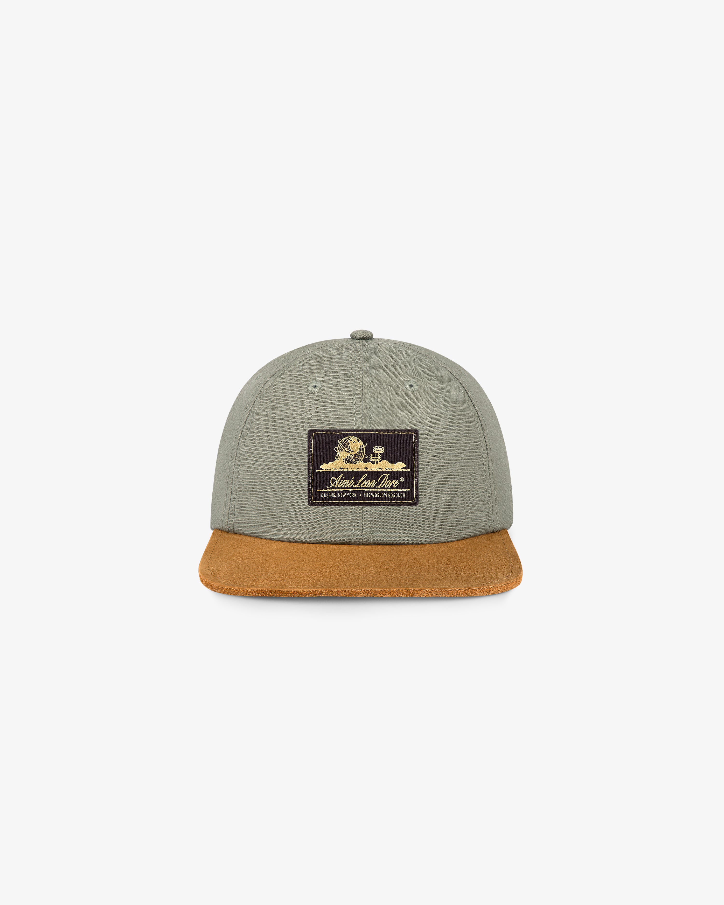 Unisphere Label Hat: gray cap with brown brim, black front patch, shown on white background.