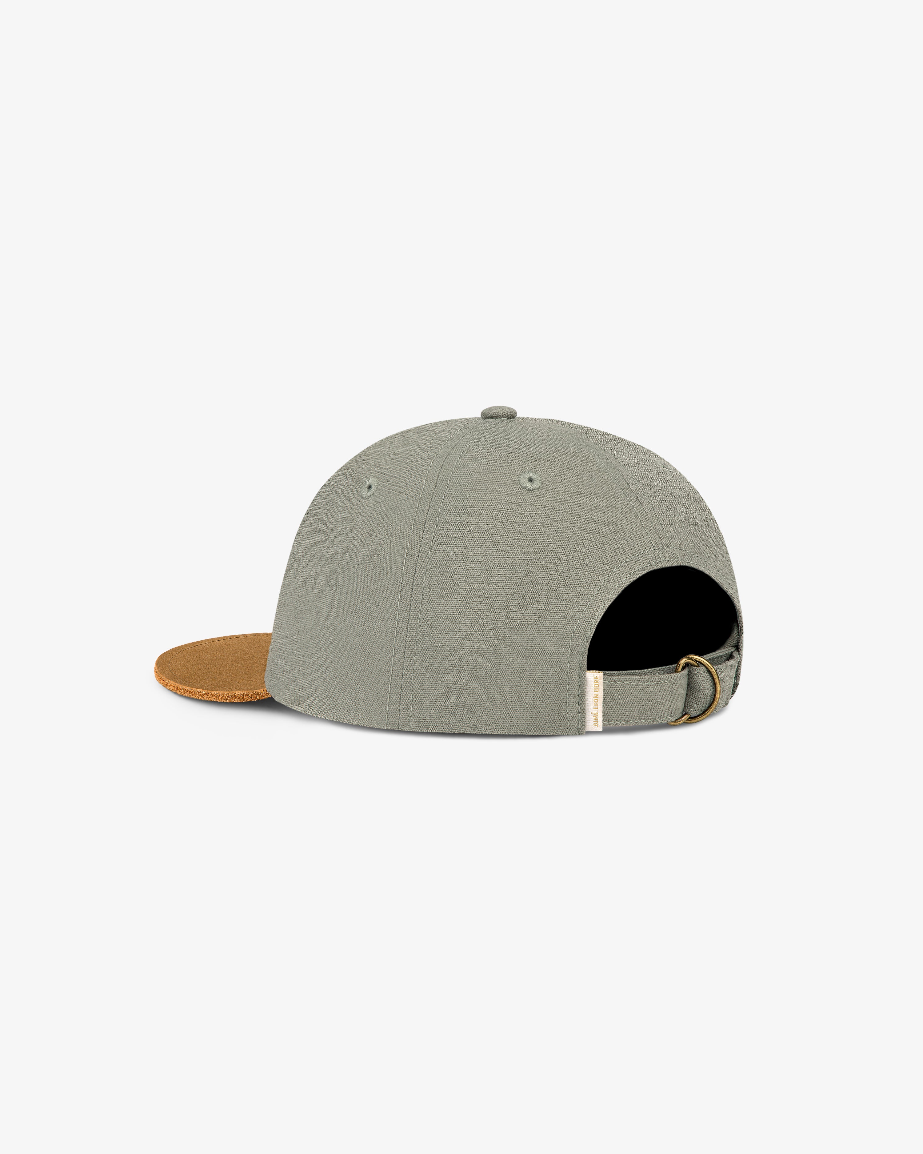 Unisphere Label Hat in gray with brown brim, back view, adjustable strap, and metal clasp.