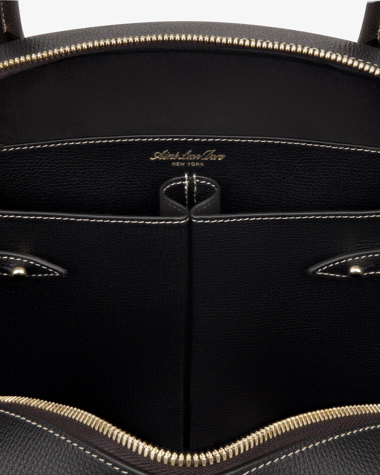 Close-up of the Full Grain Leather Crescent Shoulder Bag’s black interior with gold zipper and Sabrina Zeng New York label.