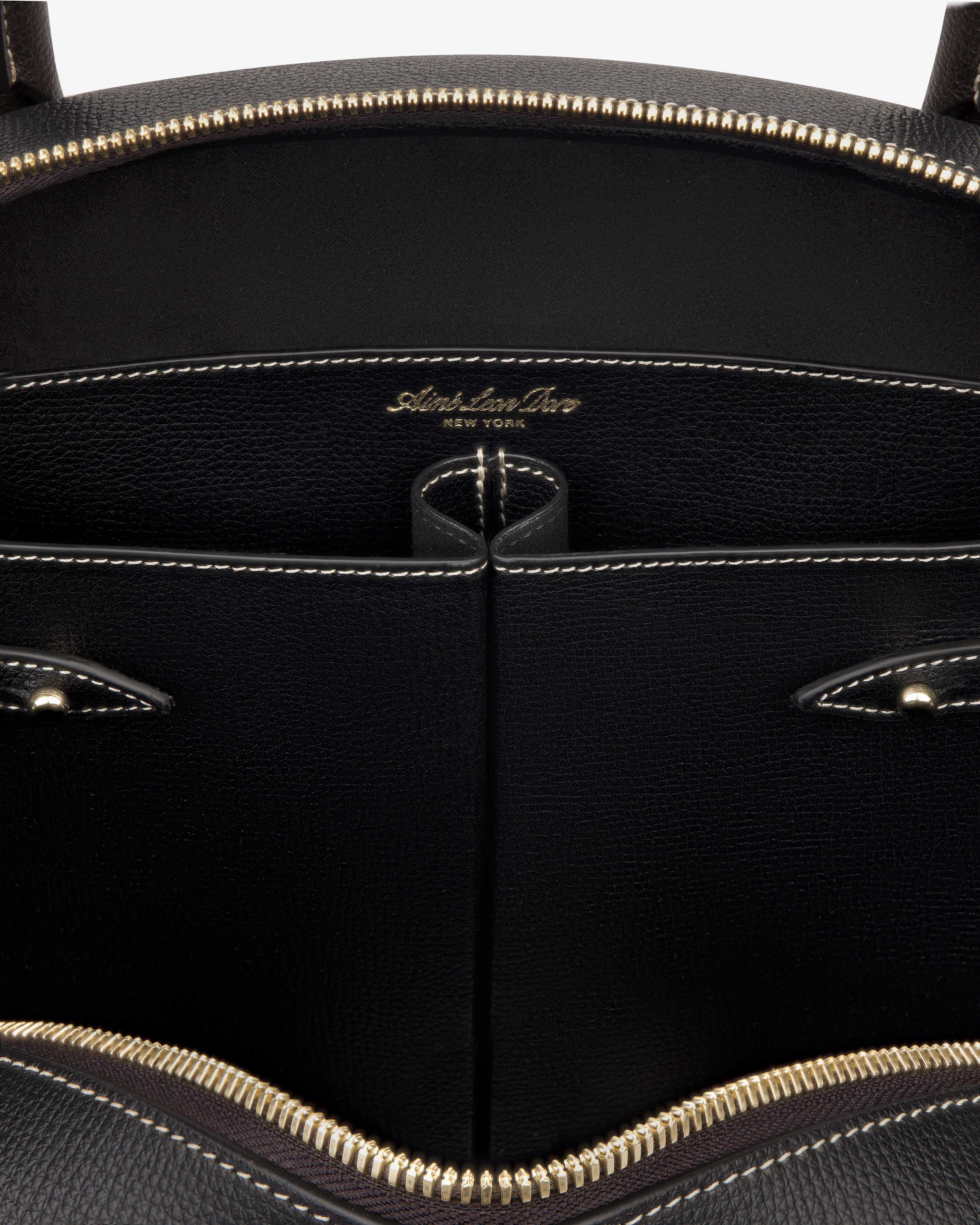 Close-up of the Full Grain Leather Crescent Shoulder Bag’s black interior with gold zipper and Sabrina Zeng New York label.