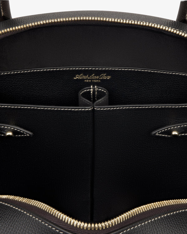 Close-up of the Full Grain Leather Crescent Shoulder Bag’s black interior with gold zipper and Sabrina Zeng New York label.