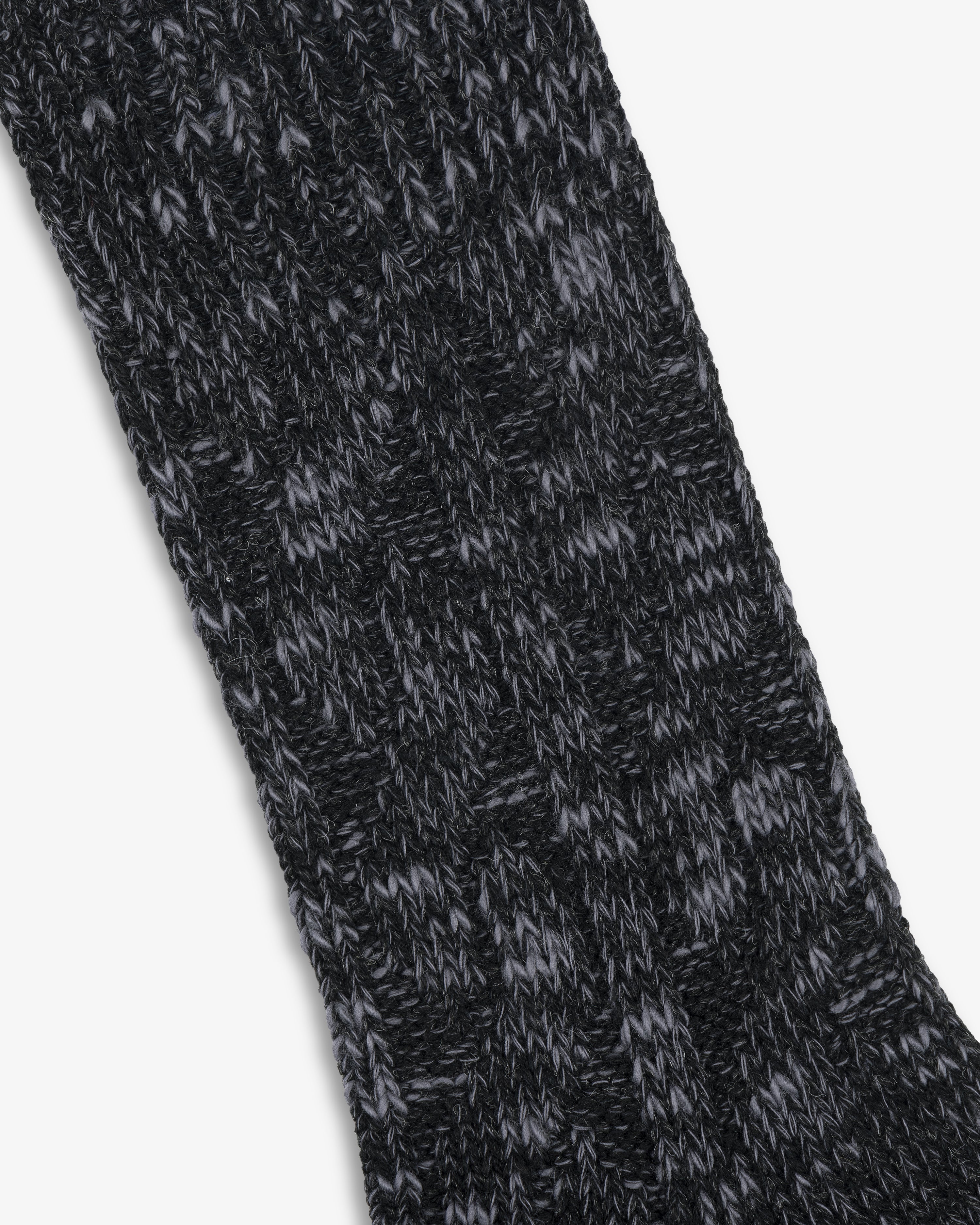 Close-up of a black and gray Cable Knit Hiking Sock featuring a textured, ribbed pattern.