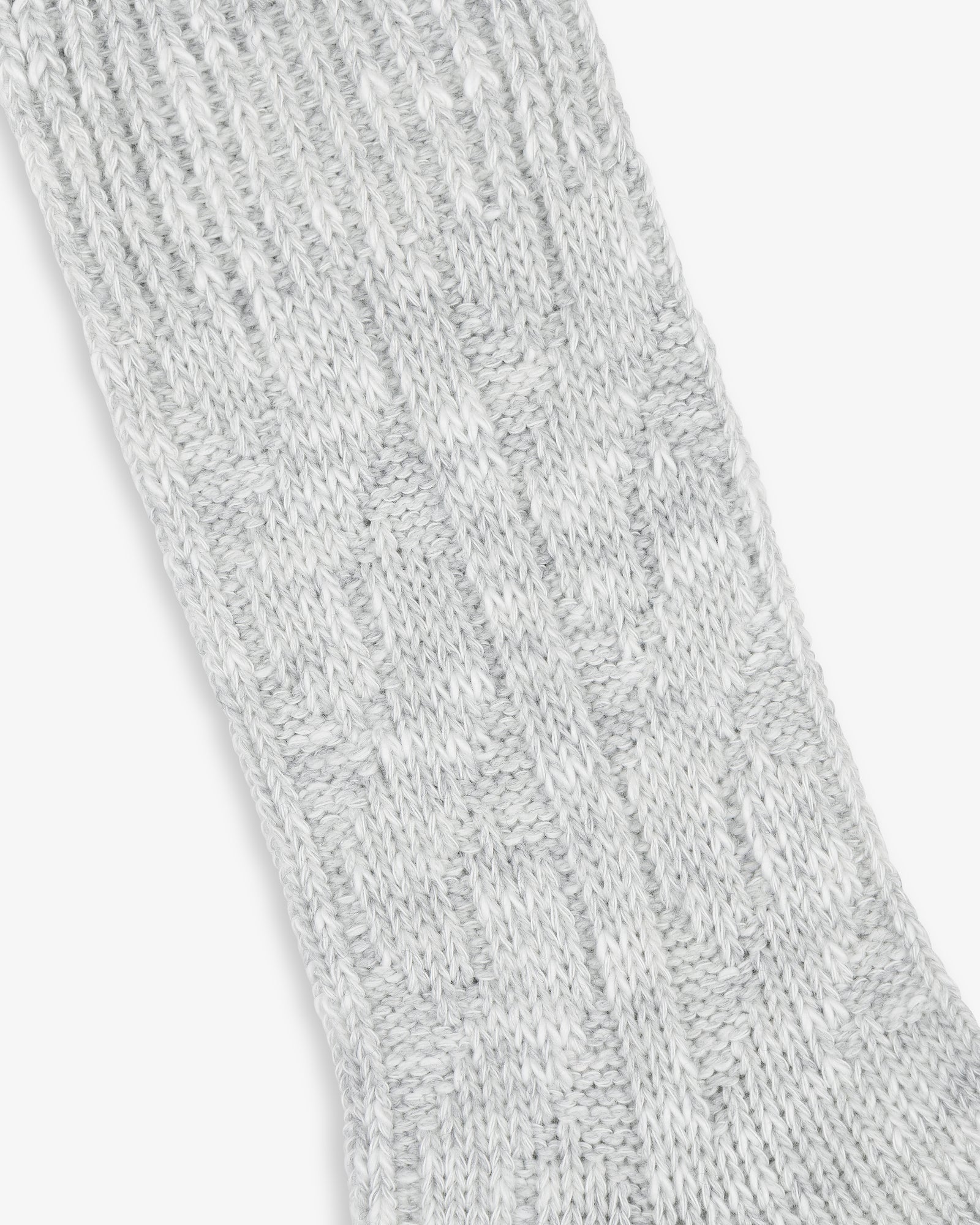 Close-up of a textured light grey Cable Knit Hiking Sock with a ribbed and patterned design.