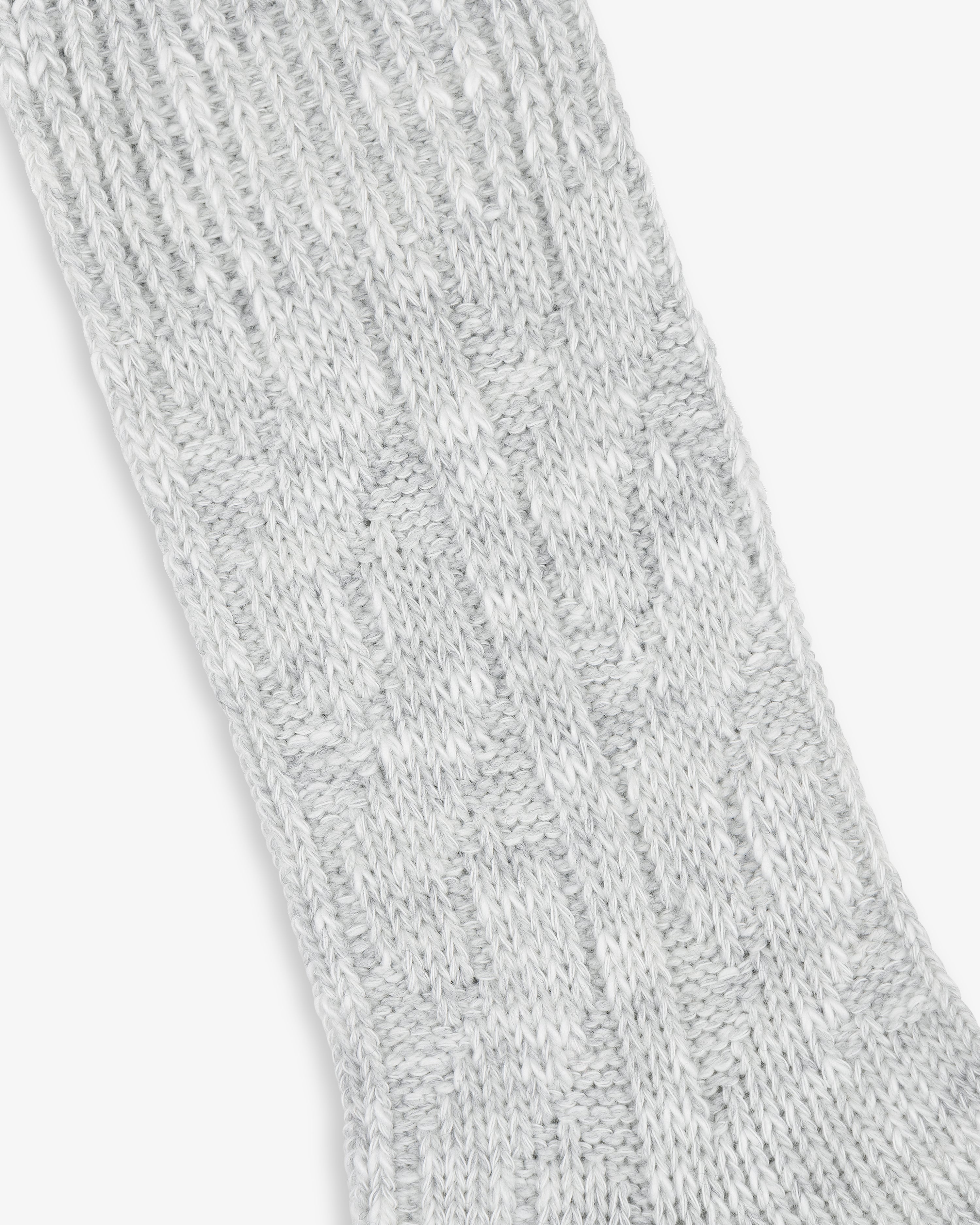 Close-up of a textured light grey Cable Knit Hiking Sock with a ribbed and patterned design.
