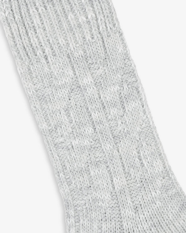 Close-up of a textured light grey Cable Knit Hiking Sock with a ribbed and patterned design.