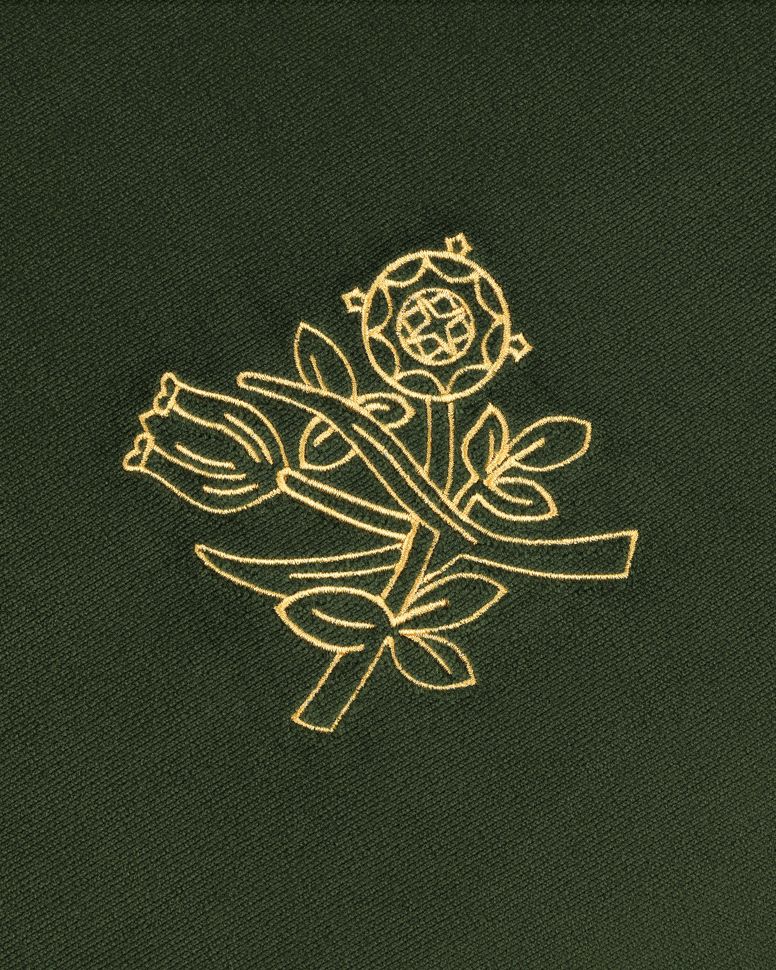 Queens Crest Throw Pillow with gold embroidered rose and floral design on dark green fabric.