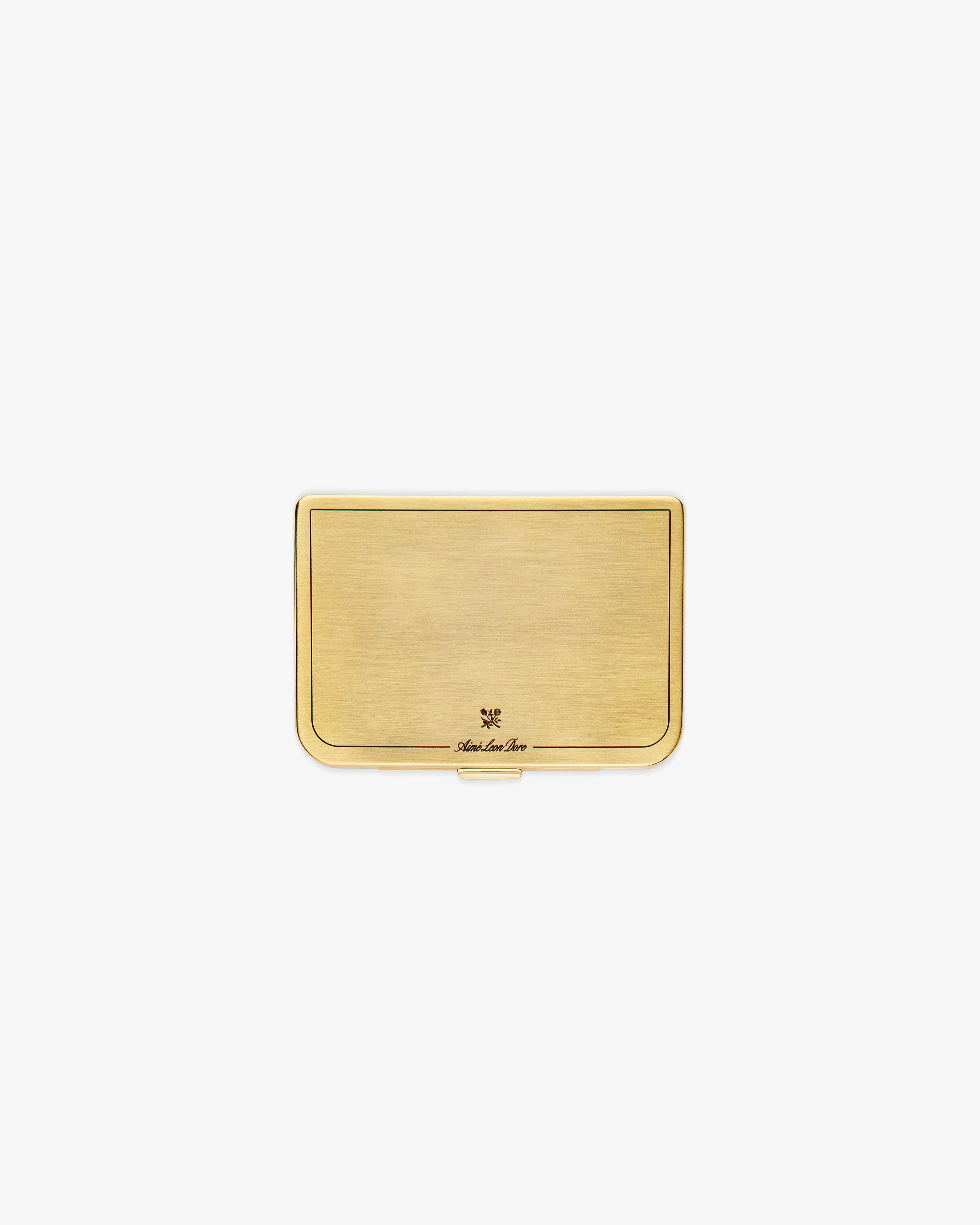 The Brass Card Case is a rectangular gold metal holder with a brushed finish and a small engraved logo at the bottom.