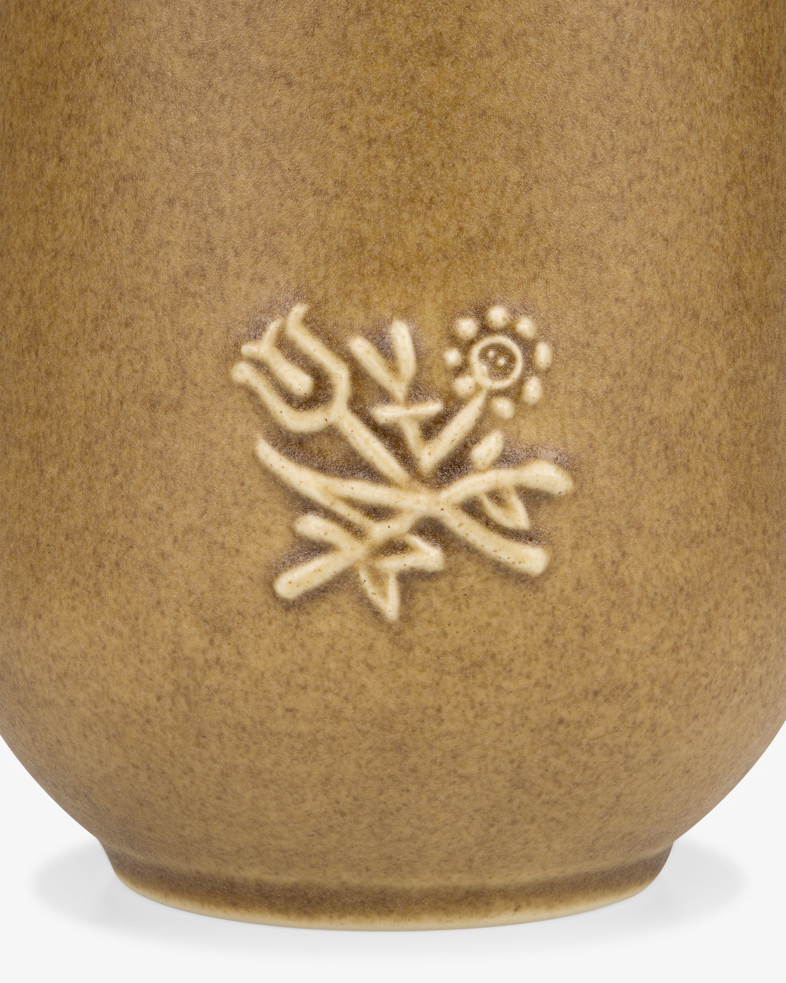 Close-up of the Queens Crest Artisanal Vase, featuring embossed tulip and daisy designs on brown ceramic.