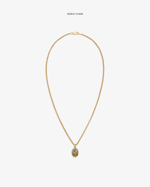 14Kt Gold Molina Pendant on a wheat chain with an intricate oval design, shown against a white background.