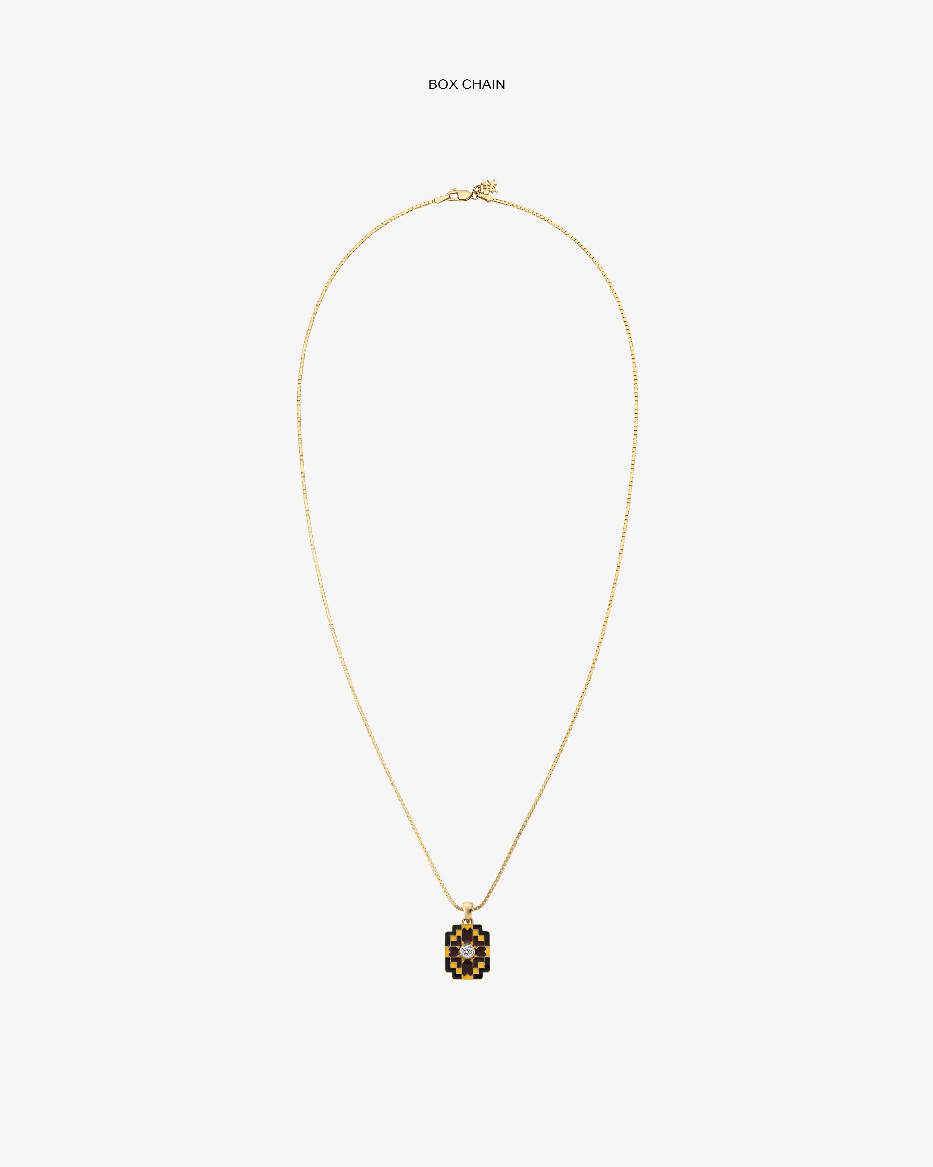 Diamond Mosaic Pendant: Gold box chain necklace with a small square pendant featuring a black and gold geometric design.