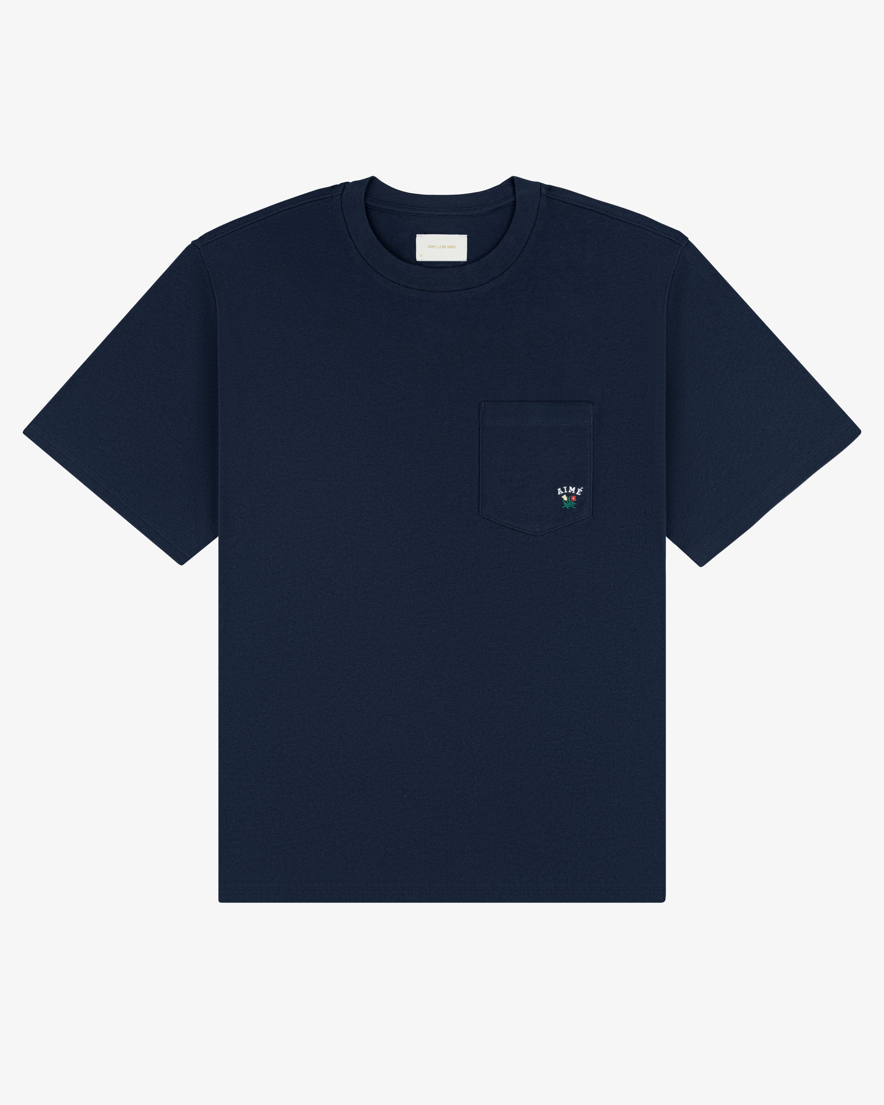 Navy Crest Pocket Tee with short sleeves, chest pocket, and small embroidered flower on the pocket.