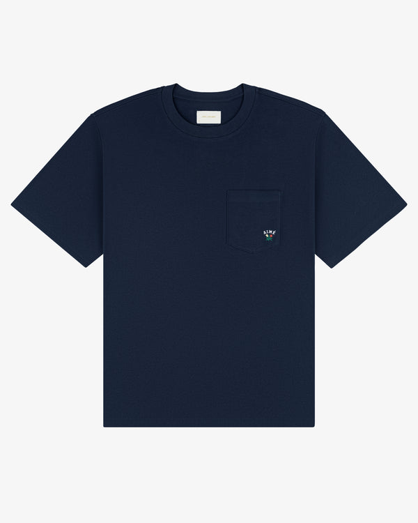 Navy Crest Pocket Tee with short sleeves, chest pocket, and small embroidered flower on the pocket.