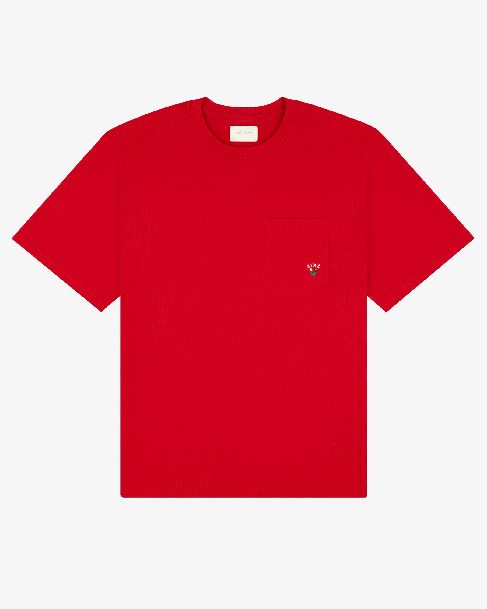 The Crest Pocket Tee is a plain red T-shirt with a chest pocket and a small embroidered strawberry on it.