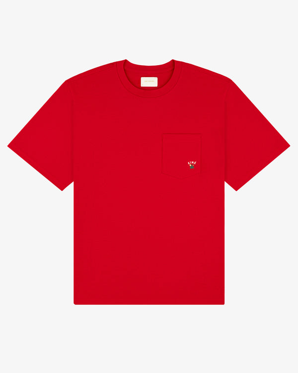 The Crest Pocket Tee is a plain red T-shirt with a chest pocket and a small embroidered strawberry on it.