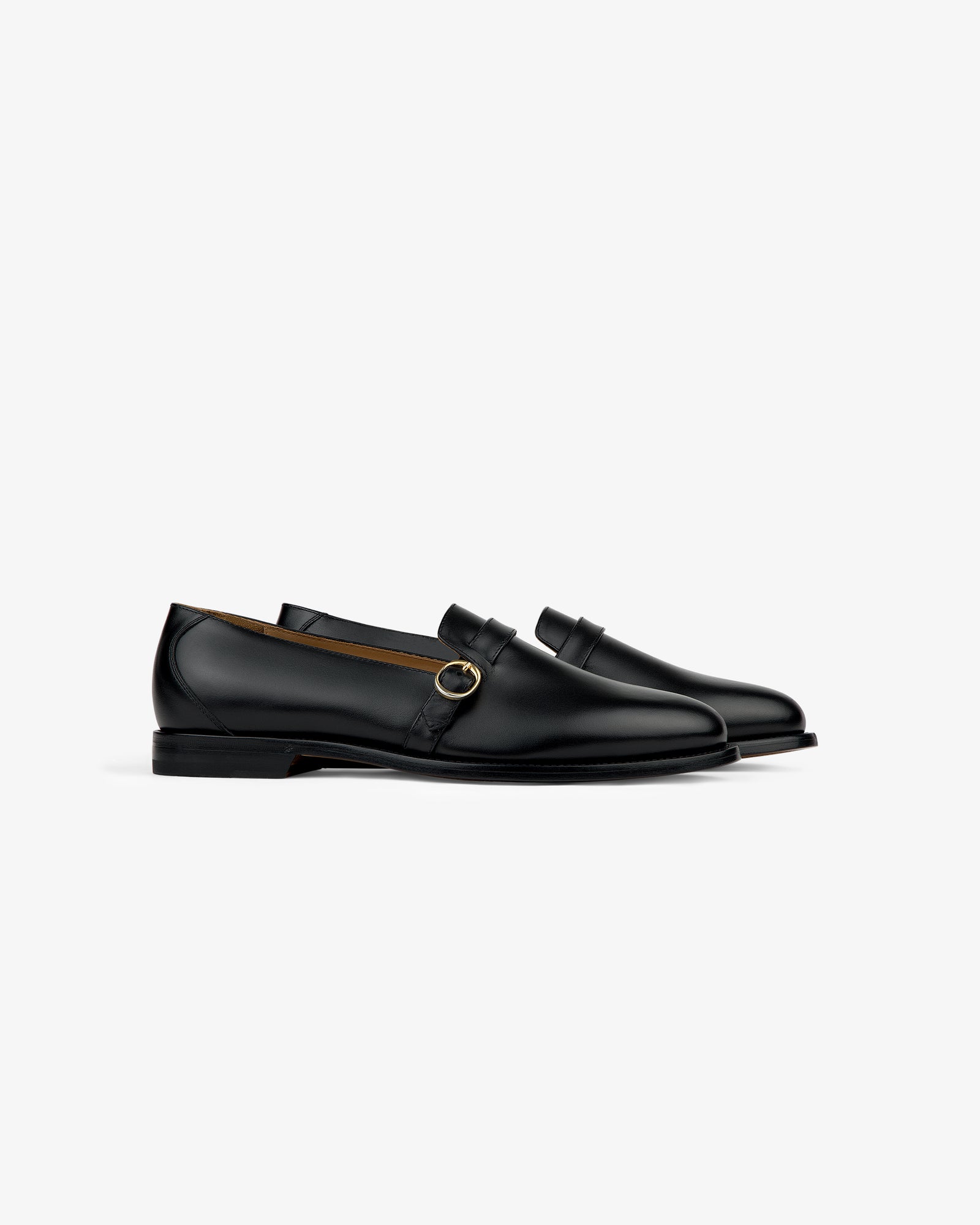 Venetian Buckle Loafer in black leather with a gold buckle, displayed in profile on a white background.
