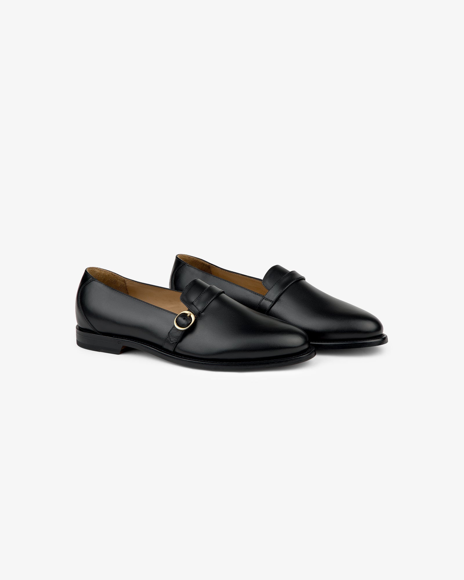 Venetian Buckle Loafer in black leather with a gold buckle, shown on a plain light gray background.