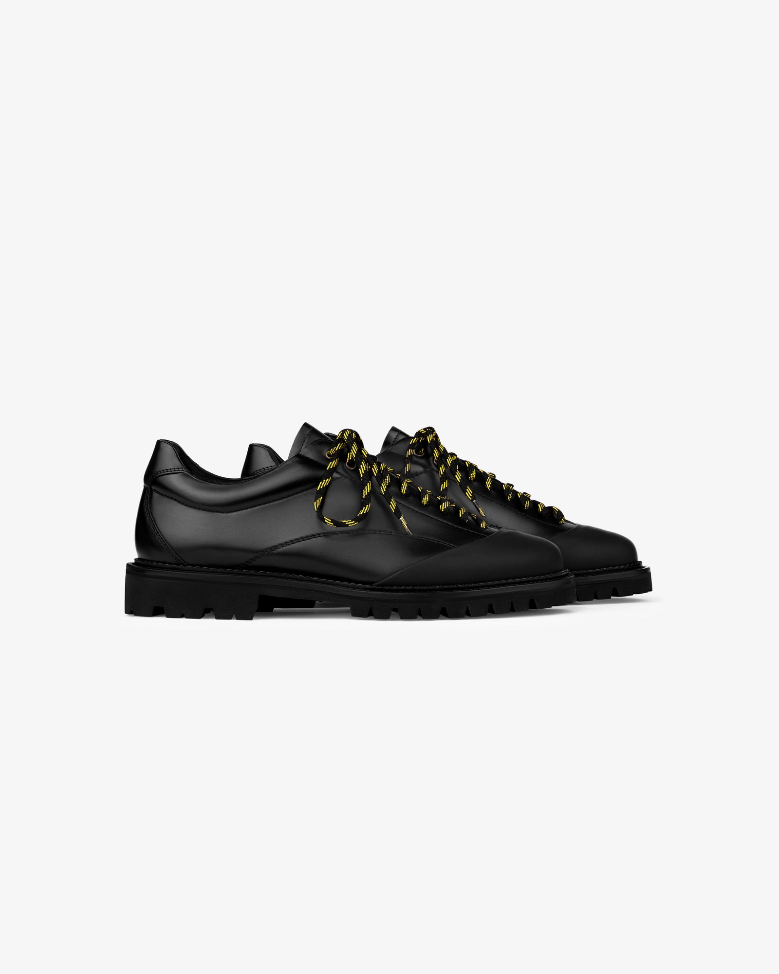 A pair of Leather Derby Hiker shoes with thick yellow-and-black striped laces on a white background.
