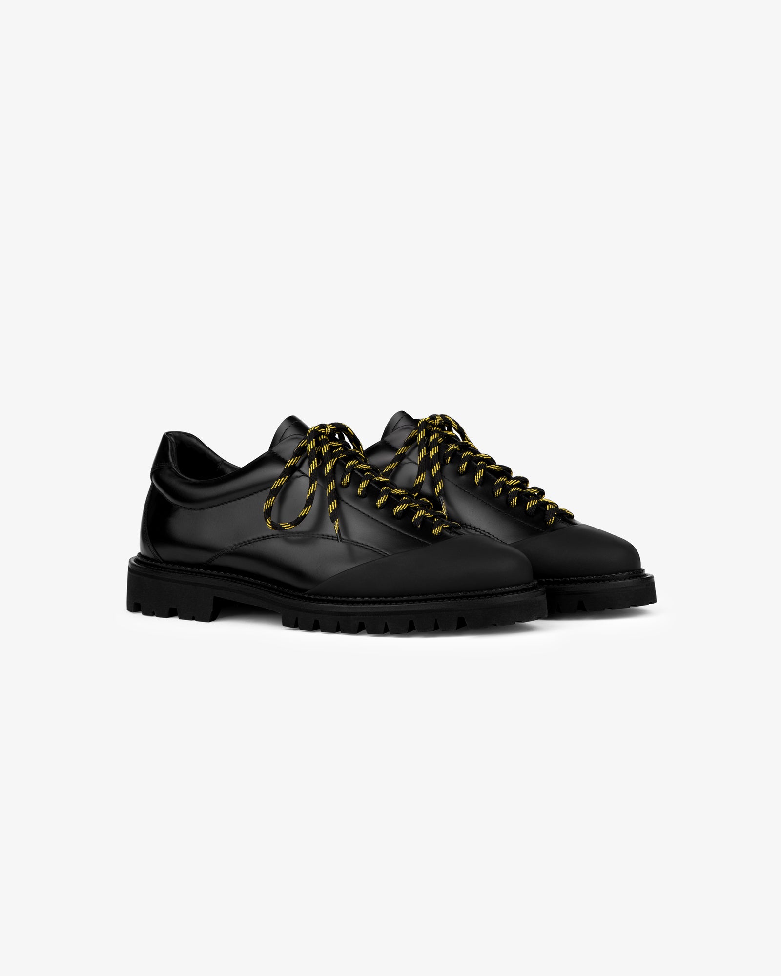Leather Derby Hiker: black leather lace-up shoes with chunky soles, yellow-black striped laces, on white background.