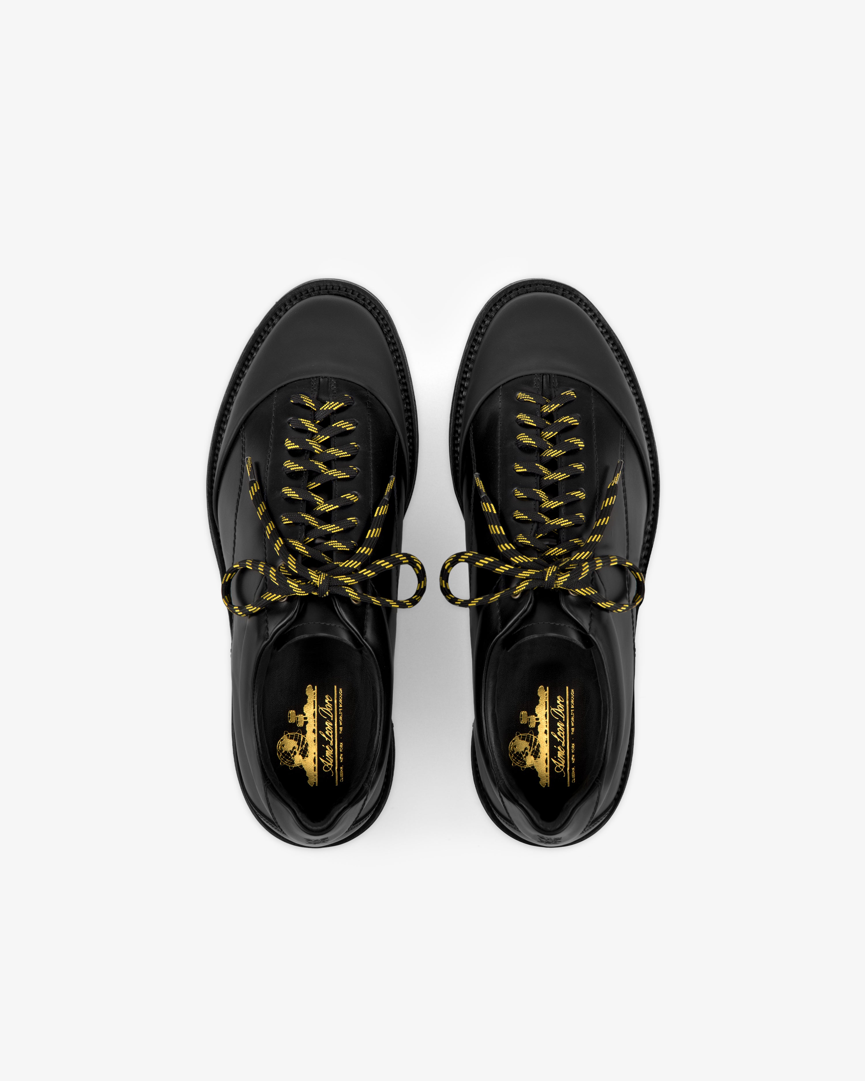 Leather Derby Hiker shoes with yellow and black striped laces, top view on a white background.