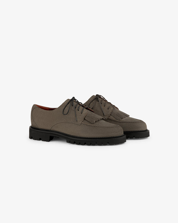 Gray Suede Lug Sole Derby shoes with lace-up front, tassels, and black lug soles.